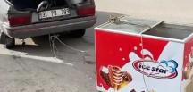 Arabasına bağladığı dondurma dolabını çekmeye çalıştı