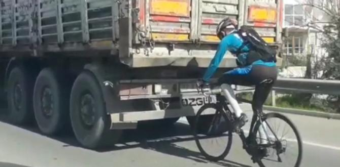 Kamyon arkasında bisikletle tehlikeli yolculuk